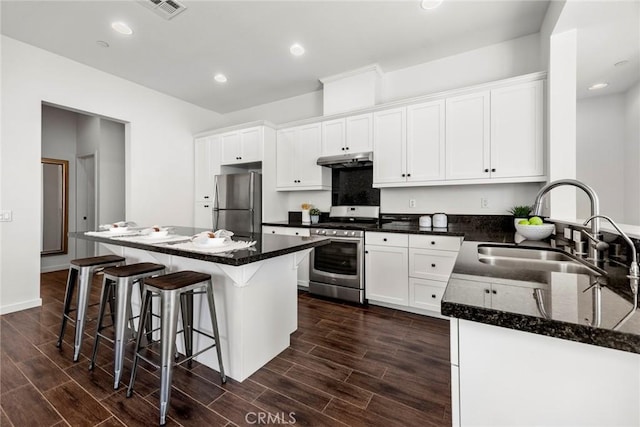144 Borrego, Irvine, CA 92618 - kitchen featuring under cabinet range hood, a sink, wood finish floors, and appliances with stainless steel finishes