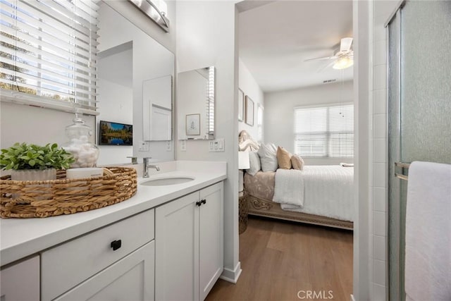 144 Borrego, Irvine, CA 92618 - bathroom with an enclosed shower, vanity, a ceiling fan, wood finished floors, and ensuite bath