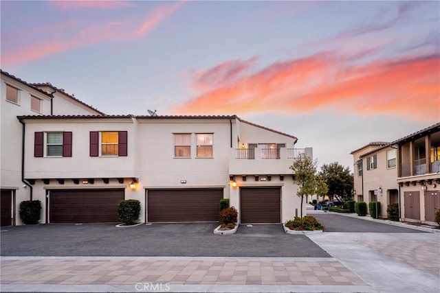 144 Borrego, Irvine, CA 92618 - view of property featuring a garage, driveway, and stucco siding