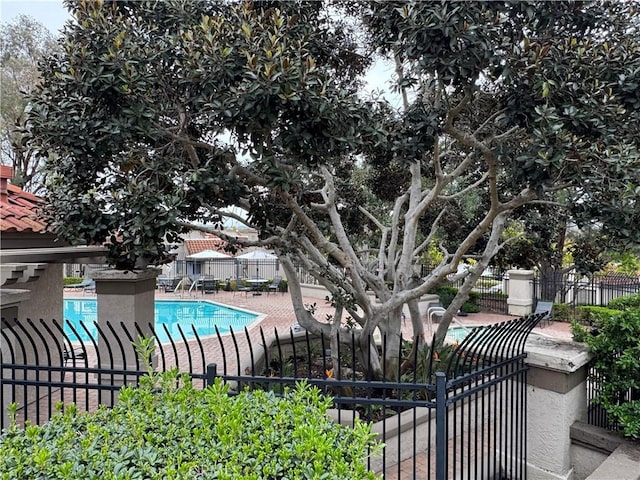 pool with fence and a patio area