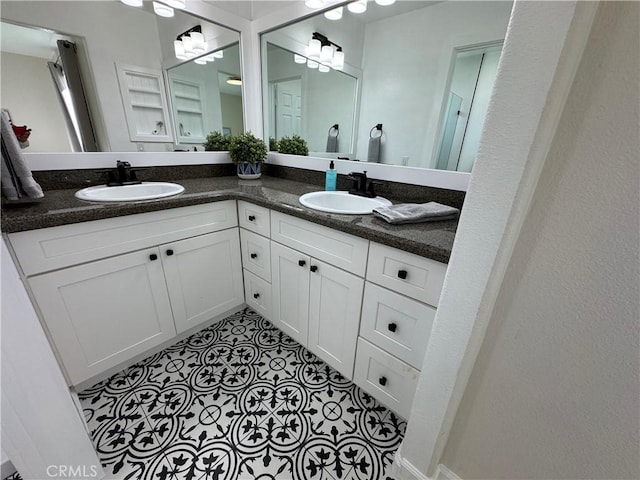 bathroom with double vanity, tile patterned floors, and a sink