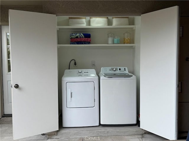 laundry room featuring light wood-type flooring, washer and dryer, and laundry area