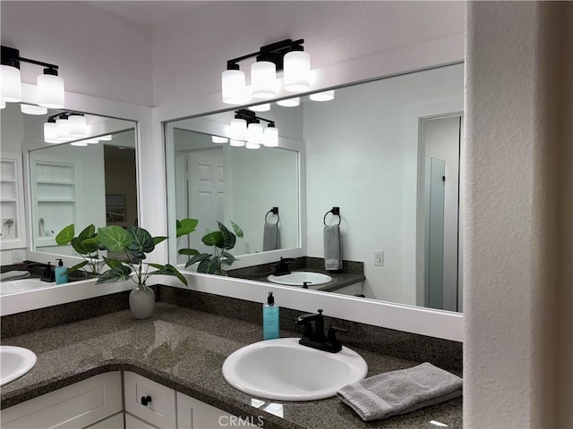 full bathroom featuring double vanity and a sink