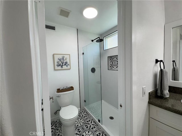 bathroom with vanity, visible vents, a shower stall, and toilet