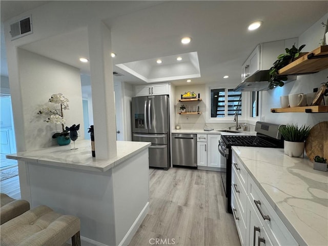 kitchen with open shelves, visible vents, light wood-style floors, appliances with stainless steel finishes, and white cabinetry