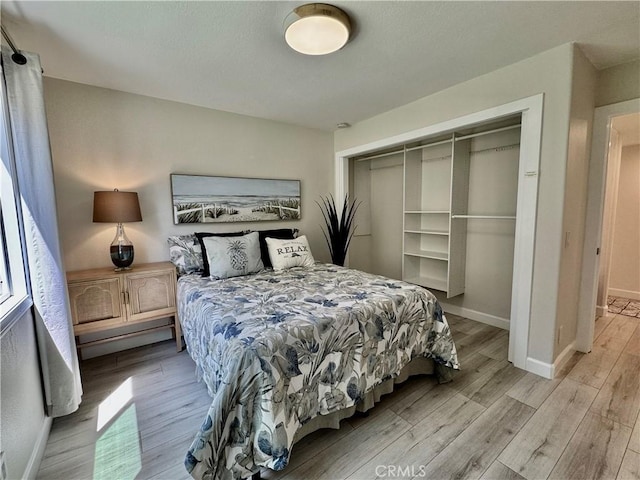 28181 Sorrento Unit 97, Laguna Niguel, CA 92677 - bedroom featuring light wood-style flooring, baseboards, and a closet