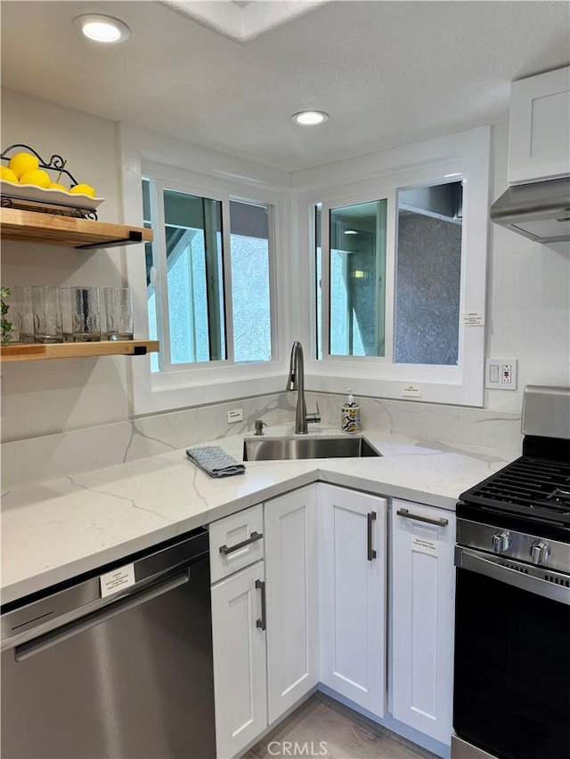 28181 Sorrento Unit 97, Laguna Niguel, CA 92677 - kitchen featuring stainless steel appliances, a sink, white cabinets, light stone countertops, and recessed lighting