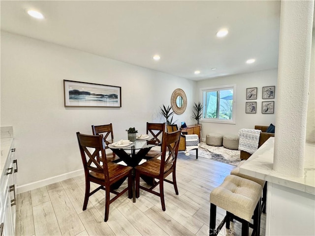 dining room with recessed lighting, light wood finished floors, and baseboards