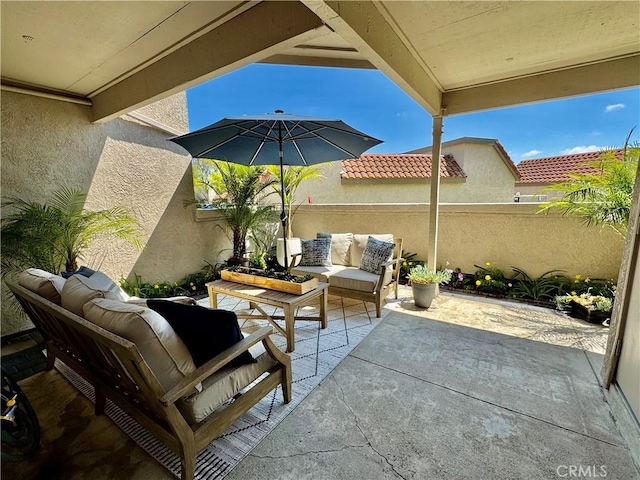 view of patio / terrace with an outdoor living space and fence