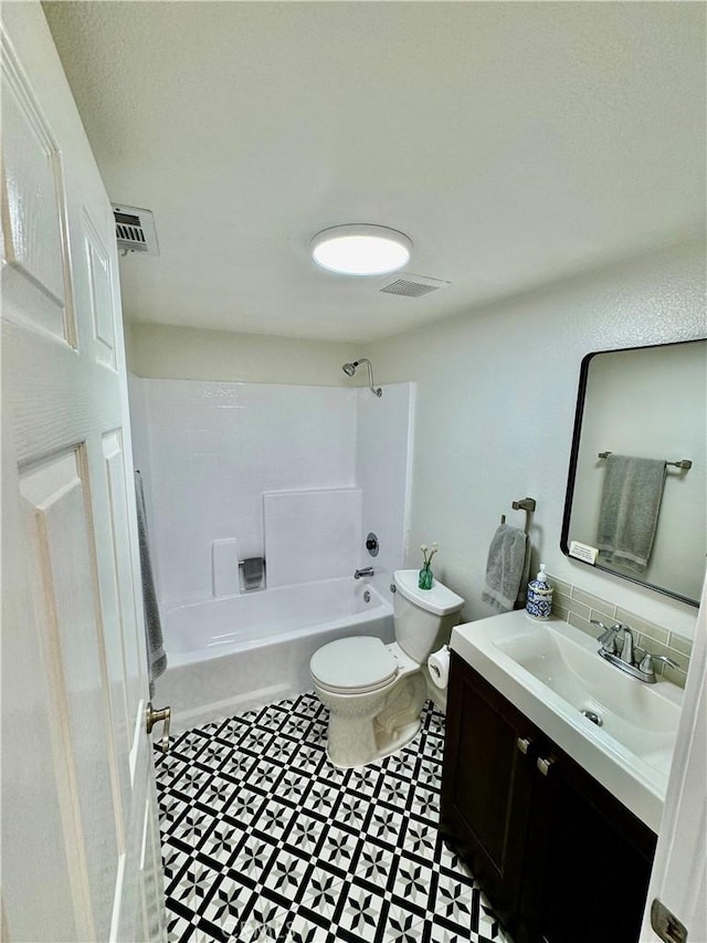 bathroom featuring toilet, vanity, shower / tub combination, and visible vents