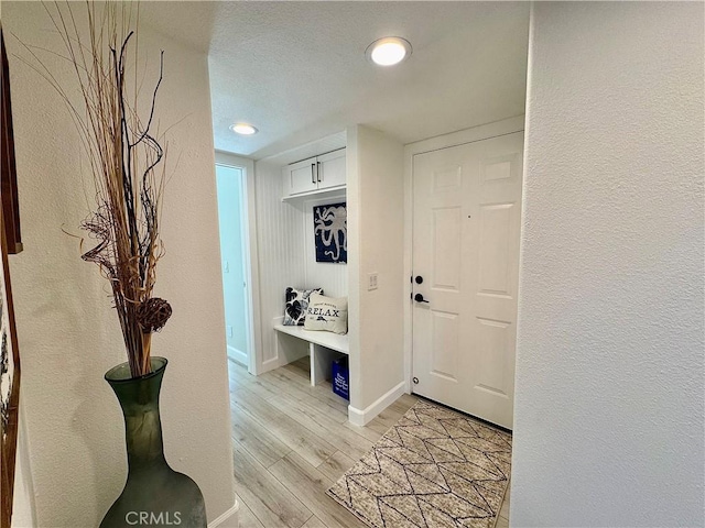 28181 Sorrento Unit 97, Laguna Niguel, CA 92677 - foyer featuring light wood-style floors, baseboards, a textured wall, and recessed lighting