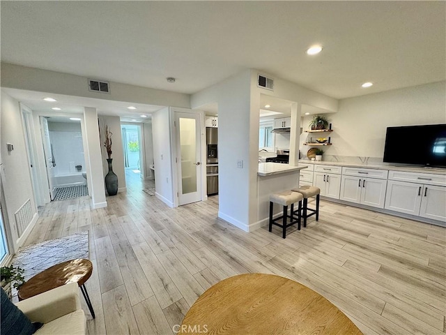 28181 Sorrento Unit 97, Laguna Niguel, CA 92677 - living room with light wood-style flooring, recessed lighting, and baseboards