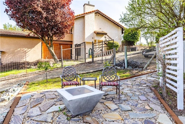 view of patio / terrace with a fire pit and fence