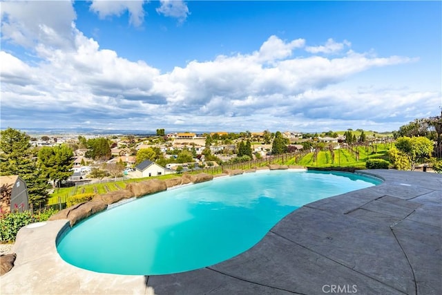outdoor pool featuring fence and a patio area