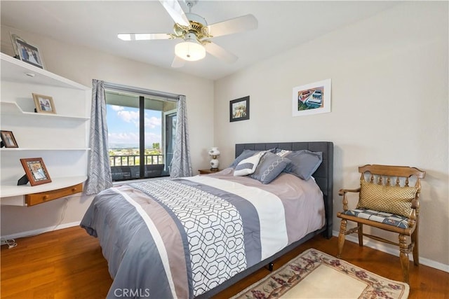 bedroom featuring baseboards, access to exterior, wood finished floors, and ceiling fan