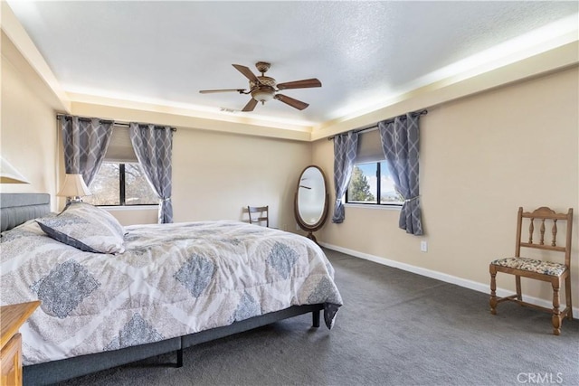 carpeted bedroom with baseboards, multiple windows, and ceiling fan