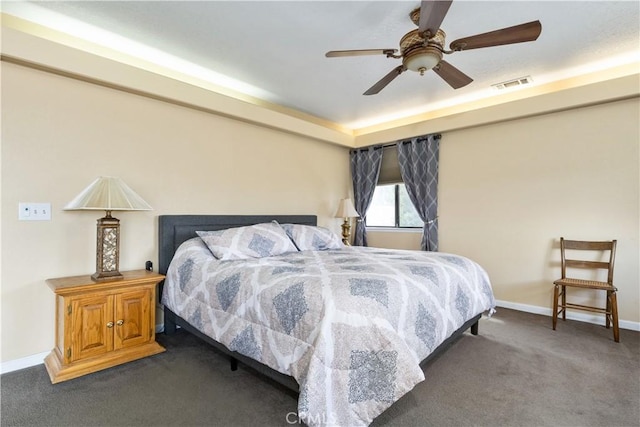 carpeted bedroom featuring baseboards, visible vents, and a ceiling fan