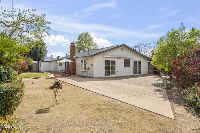 1414 Meadowbrook Rd, Ojai, CA 93023 - rear view of house with a patio, fence, stucco siding, a chimney, and driveway