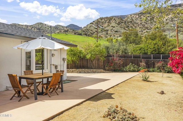 1414 Meadowbrook Rd, Ojai, CA 93023 - view of patio featuring a mountain view, fence, and outdoor dining space