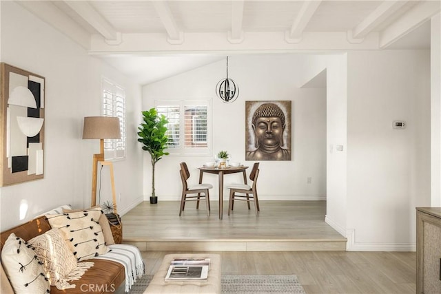 living area featuring lofted ceiling with beams, baseboards, and light wood-type flooring