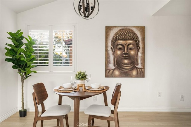 dining room with an inviting chandelier, baseboards, and wood finished floors