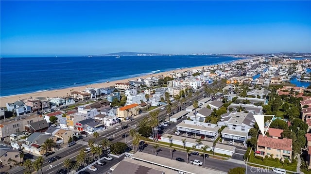 bird's eye view featuring a water view and a beach view