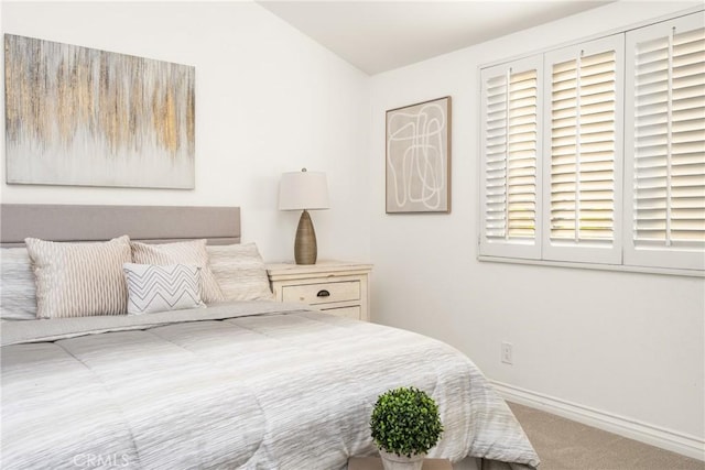carpeted bedroom featuring baseboards