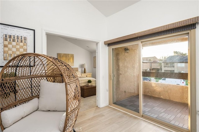 bedroom with lofted ceiling and wood finished floors