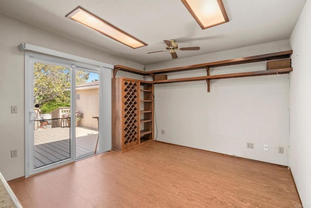 empty room with ceiling fan and wood finished floors