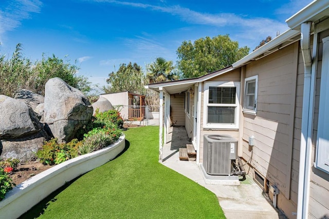 view of yard featuring central air condition unit and fence