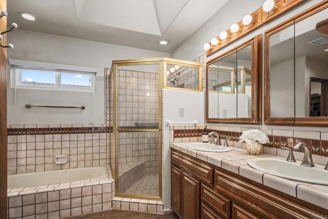 bathroom with double vanity, a sink, a stall shower, and visible vents