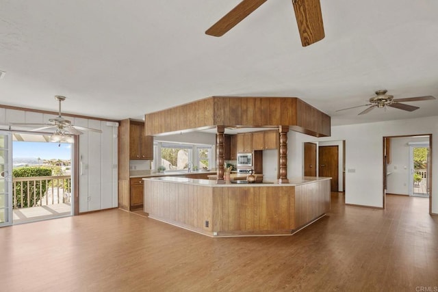 kitchen with ceiling fan, stainless steel microwave, and plenty of natural light