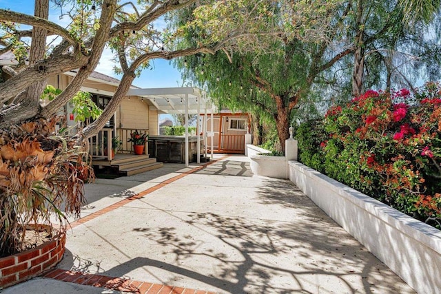 view of patio / terrace with a jacuzzi and a wooden deck