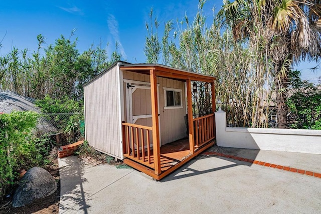 view of shed featuring fence