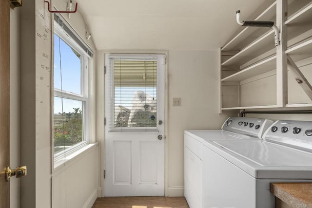 laundry room featuring baseboards, laundry area, light wood-style floors, and washer and dryer
