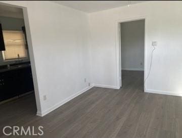 410 N San Jacinto St, Hemet, CA 92543 - empty room with dark wood-style floors and baseboards