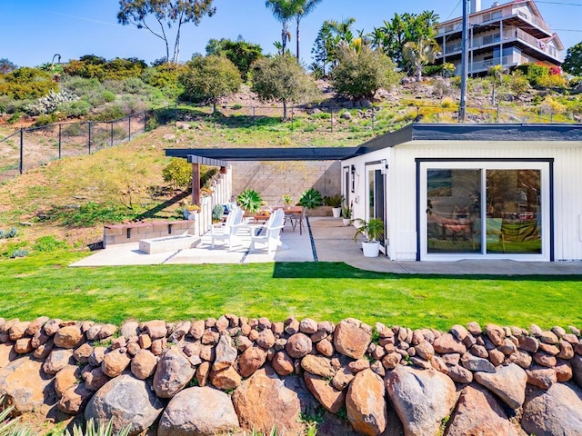back of property with a yard, a pergola, fence, and a patio area