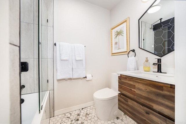 bathroom with tile patterned flooring, shower / bath combination with glass door, vanity, toilet, and baseboards