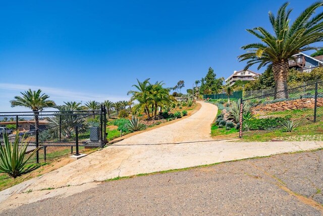 view of property's community with a gate and fence