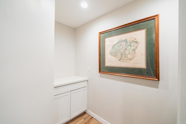 room details with baseboards and wood finished floors