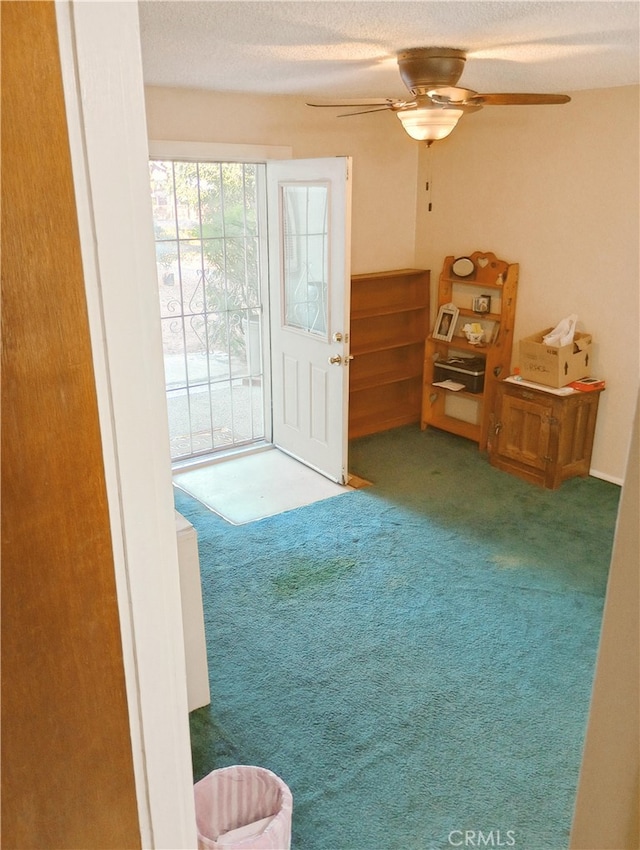interior space with ceiling fan and carpet
