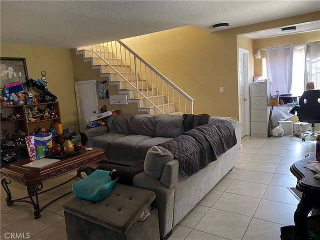 698 W Phillips Blvd, Pomona, CA 91766 - tiled living room with a textured ceiling and stairway