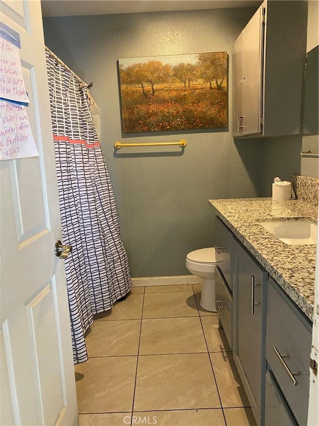 698 W Phillips Blvd, Pomona, CA 91766 - full bath with vanity, toilet, baseboards, tile patterned floors, and curtained shower