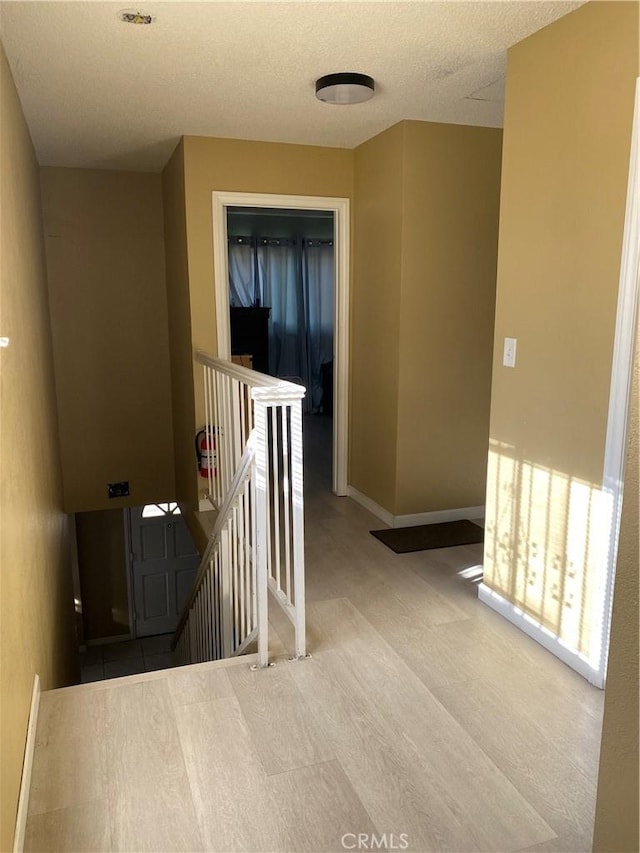 698 W Phillips Blvd, Pomona, CA 91766 - hall featuring an upstairs landing, baseboards, and a textured ceiling