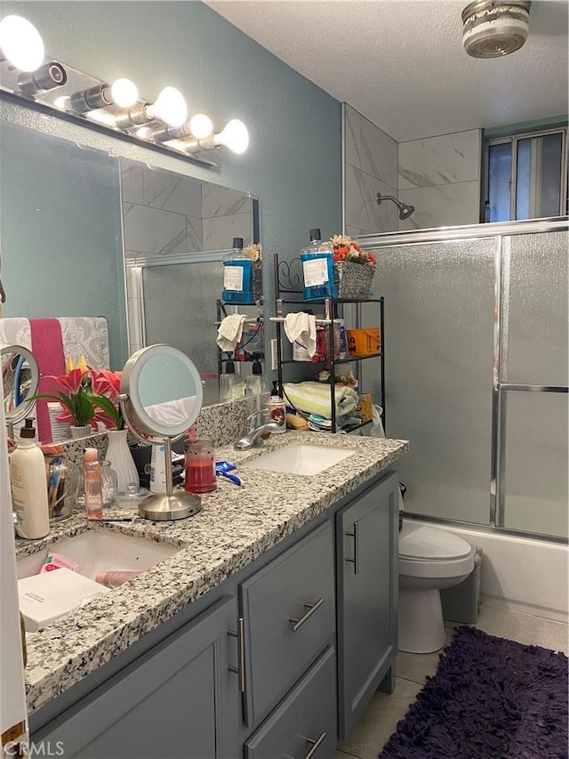 698 W Phillips Blvd, Pomona, CA 91766 - bathroom featuring double vanity, a textured ceiling, a sink, and toilet
