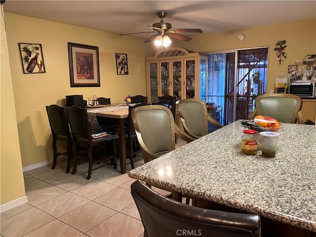 698 W Phillips Blvd, Pomona, CA 91766 - dining space featuring baseboards, ceiling fan, and light tile patterned floors