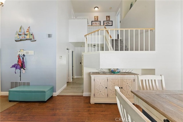 3140 Timberline Dr, Corona, CA 92882 - interior space featuring visible vents, baseboards, a towering ceiling, wood finished floors, and stairs