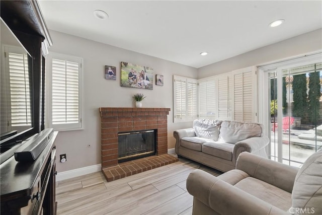 3140 Timberline Dr, Corona, CA 92882 - living area featuring light wood-style floors, recessed lighting, a brick fireplace, and baseboards
