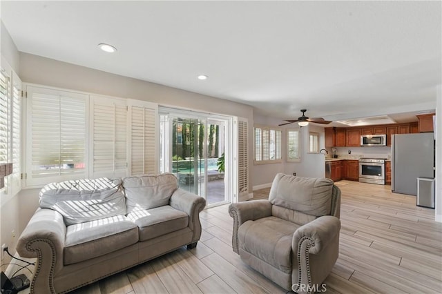 3140 Timberline Dr, Corona, CA 92882 - living area featuring ceiling fan, recessed lighting, light wood-style floors, and baseboards