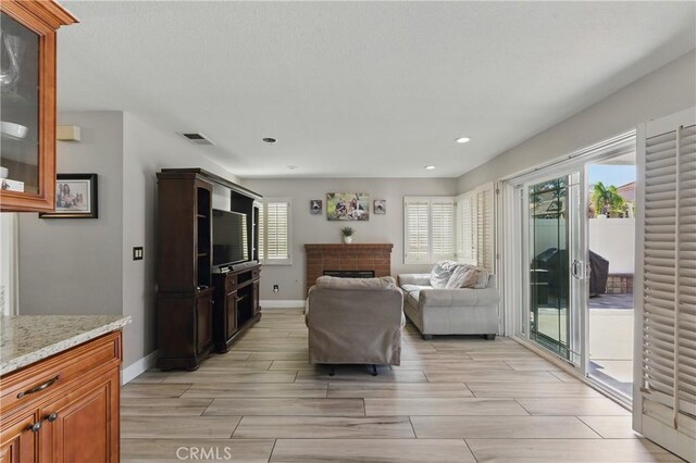 3140 Timberline Dr, Corona, CA 92882 - living area with baseboards, wood finish floors, recessed lighting, a fireplace, and visible vents